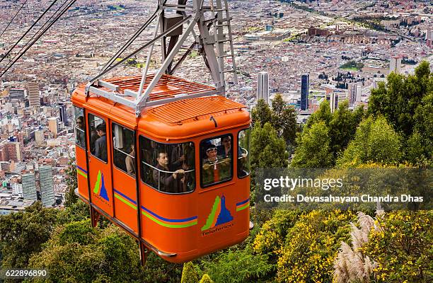 bogota, colombia - a cable car approaches the andes mountain peak of monserrate 1,500 feet above the capital city which is located at about 8,500 feet above mean sea level. - monserrate bogota stock pictures, royalty-free photos & images