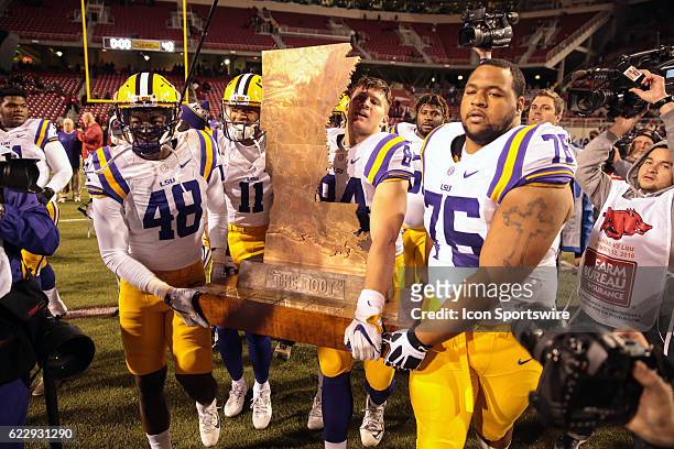 The LSU Tigers carry "The Boot" to their side of the field after an NCAA football game between the Louisiana State University Tigers and the Arkansas...