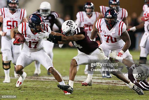 Evan Engram of the Mississippi Rebels fends off Justin Evans of the Texas A&M Aggies in the fourth quarter at Kyle Field on November 12, 2016 in...