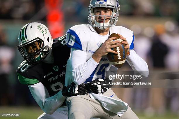 Middle Tennessee Blue Raiders QB John Urzua is sacked by Marshall Thundering Herd DL Damien Dozier during the third quarter of the quarter of the...