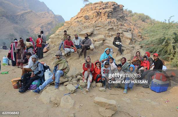 Pakistani devotees wait for transport on their return home from the shrine of Sufi saint Shah Noorani, some 750 kilometres south of Quetta, on...
