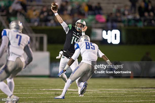 Marshall Thundering Herd S Kendall Gant throws a pass as Middle Tennessee Blue Raiders DE Darrius Liggins applies pressure during the third quarter...