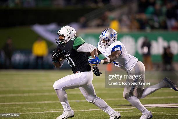 Middle Tennessee Blue Raiders LB D.J. Sanders makes the tackle on Marshall Thundering Herd RB Anthony Anderson during the second quarter of the...