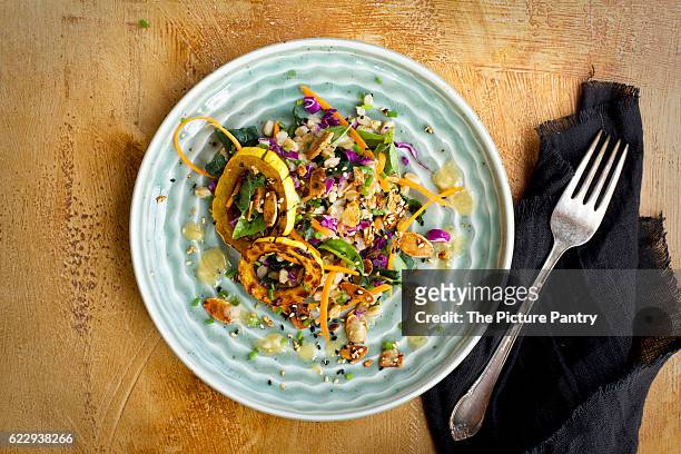sesame farro salad with delicata squash served with dressing, toasted nuts, and chives - delicata squash stock pictures, royalty-free photos & images