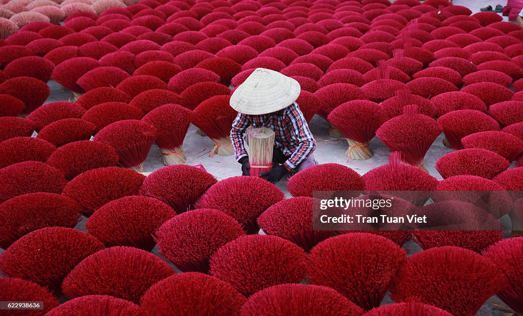 Vietnam - woman making red insense
