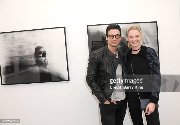 Actor Steven Strait and Dario Zhemkova attend 'Hindsight Is 30/40 - A Group Photographer Exhibition' at The Salon at Automatic Sweat on November 12,...