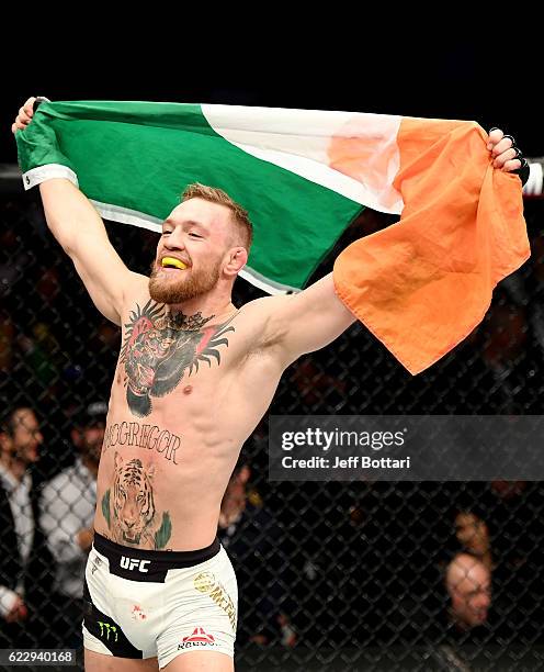 Conor McGregor of Ireland celebrates his KO victory over Eddie Alvarez of the United States in their lightweight championship bout during the UFC 205...