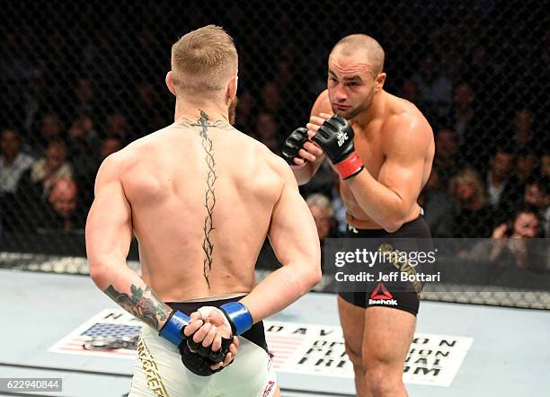 Eddie Alvarez of the United States fights against Conor McGregor of Ireland in their lightweight championship bout during the UFC 205 event at...