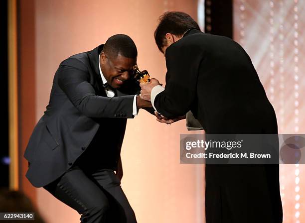 Actor Chris Tucker presents an award onstage to honoree Jackie Chan during the Academy of Motion Picture Arts and Sciences' 8th annual Governors...