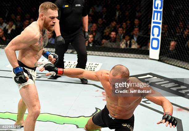 Eddie Alvarez of the United States fights against Conor McGregor of Ireland in their lightweight championship bout during the UFC 205 event at...