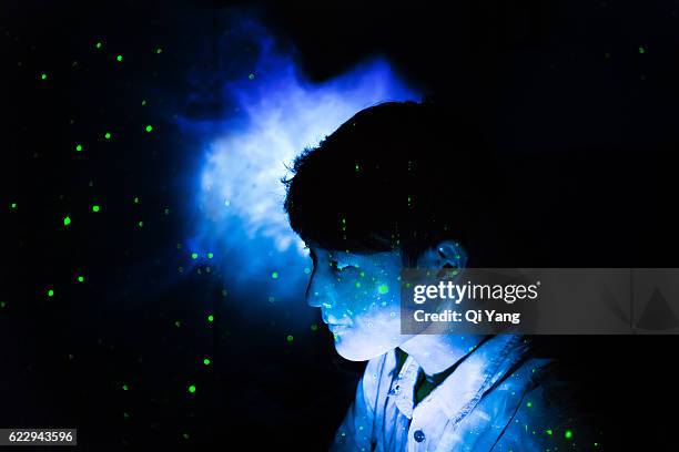 stars projected onto the young man's face - light discovery stock pictures, royalty-free photos & images