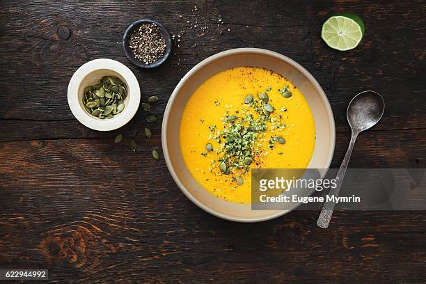 pumpkin soup with coconut and seeds - soup stock pictures, royalty-free photos & images