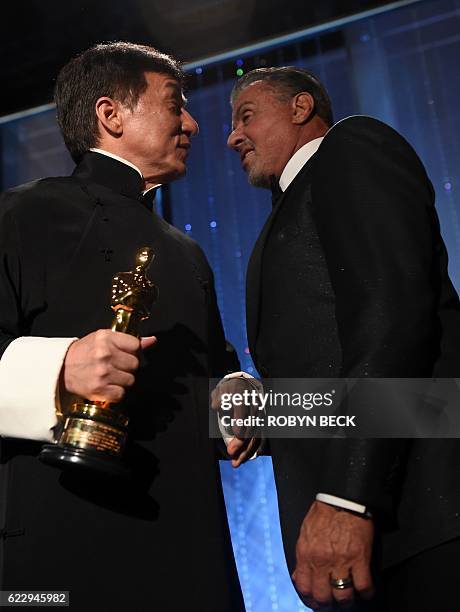 Honoree Jackie Chan talks with actor Sylvester Stallone after Chan accepted his Honorary Oscar Award during the 8th Annual Governors Awards hosted by...