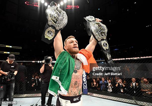 Conor McGregor of Ireland celebrates his KO victory over Eddie Alvarez of the United States in their lightweight championship bout during the UFC 205...