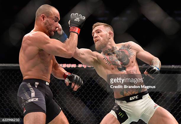 Conor McGregor of Ireland punches Eddie Alvarez in their UFC lightweight championship fight in their UFC lightweight championship fight during the...