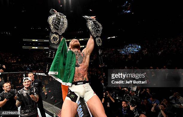 Conor McGregor of Ireland celebrates his KO victory over Eddie Alvarez of the United States in their lightweight championship bout during the UFC 205...