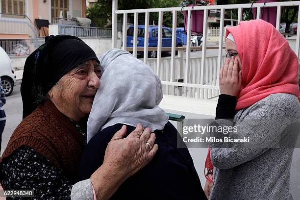 Greek neighbour says goodbye and cries with Syrian Refugees, Sham Asaaid Alkhateb and Doha Asaaid Alkhateb at their temporary home in Athens, the day...