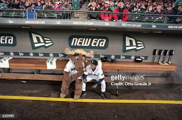 Ichiro Suzuki of the Seattle Mariners hangs with the Mascot in the dug out during the game against the Oakland Athletics at Safco Field in Seattle,...
