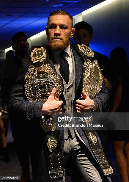 Featherweight and lightweight champion Conor McGregor of Ireland enters the UFC 205 post fight press conference at Madison Square Garden on November...