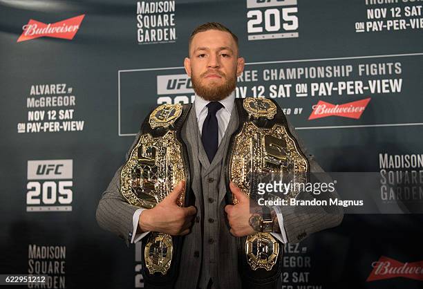 Featherweight and lightweight champion Conor McGregor of Ireland poses for a picture during the UFC 205 post fight press conference at Madison Square...