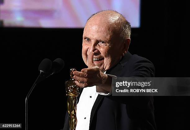 Casting director Lynn Stalmaster gestures on stage after receiving his honorary Oscar award during the 8th Annual Governors Awards hosted by the...