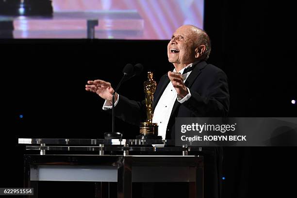 Casting director Lynn Stalmaster reacts on stage after receiving his honorary Oscar award during the 8th Annual Governors Awards hosted by the...