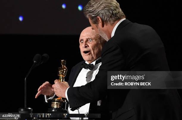 Actor Jeff Bridges presents an honorary Oscar award to casting director Lynn Stalmaster on stage during the 8th Annual Governors Awards hosted by the...