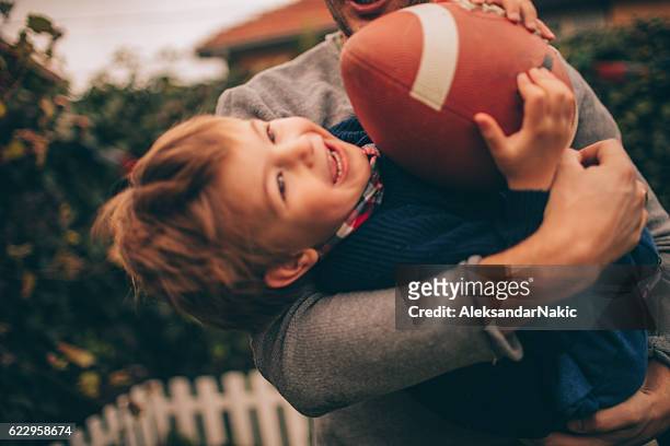 sports with my dad - american football family stock pictures, royalty-free photos & images