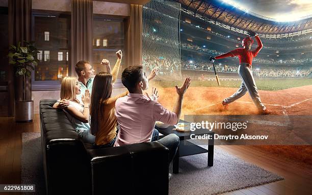 students watching very realistic baseball game at home - baseball fans stock pictures, royalty-free photos & images