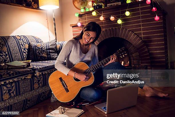 beautiful young woman playing the guitar - hot latin nights stock pictures, royalty-free photos & images