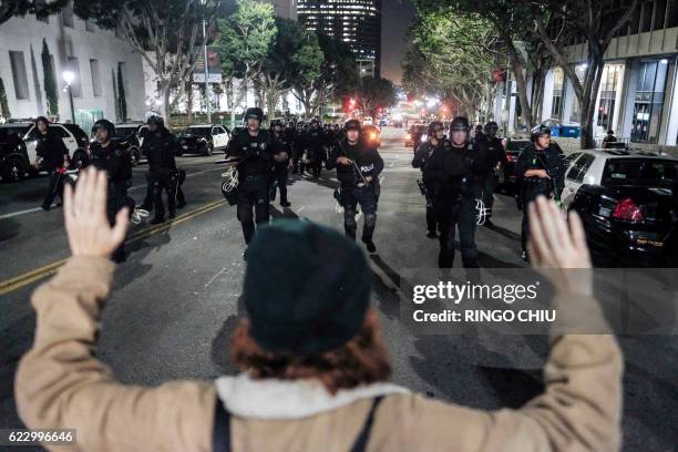 Police in riot gear confront demonstrators outside City Hall during a protest against US President-elect Donald Trump in Los Angeles, California, on...