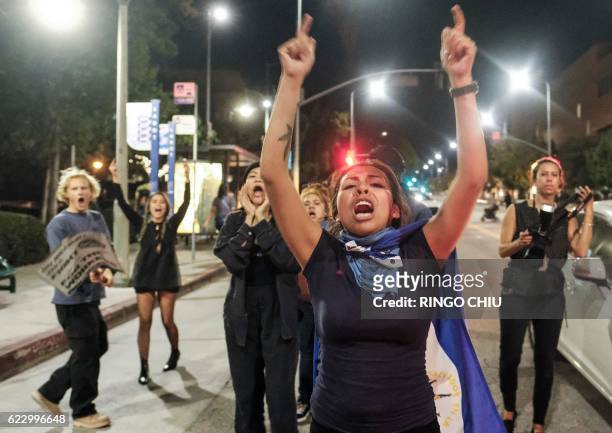 Demonstrators gather outside City Hall during a protest against US President-elect Donald Trump in Los Angeles, California, on November 13, 2016. Los...