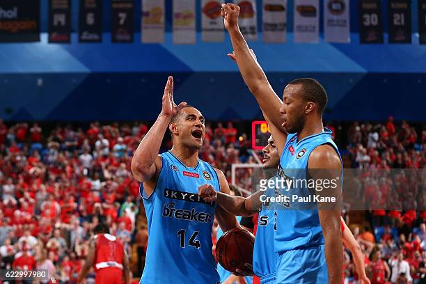 Mika Vukona of the Breakers celebrates wining in overtime with Corey Webster and Akil Mitchell of the Breakers during the round six NBL match between...