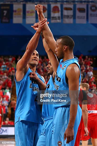 Mika Vukona of the Breakers celebrates wining in overtime with Corey Webster and Akil Mitchell of the Breakers during the round six NBL match between...