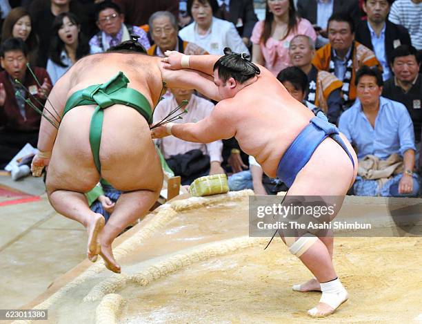 Ozeki Kotoshogiku throws Brazilian wrestler Kaisei to win during day one of the Grand Sumo Kyushu Tournament at Fukuoka Convention Center on November...