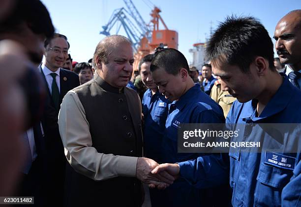 Pakistan's Prime Minister Nawaz Sharif meets with Chinese workers at a ceremony to open a pilot trade project in Gwadar port, some 700 kms west of...