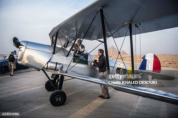 Belgian pilots Alexandra Maingard and her husband Cedric Collette prepare their bi-plane in an airfield near the Pyramids of Giza, on the southern...