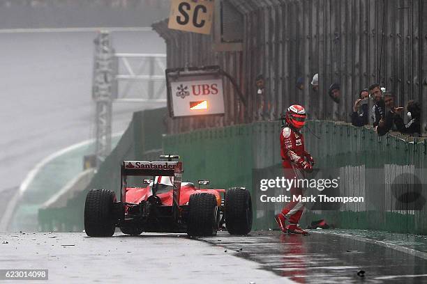 Kimi Raikkonen of Finland and Ferrari gets out of his car after crashing on the pit straight during the Formula One Grand Prix of Brazil at Autodromo...