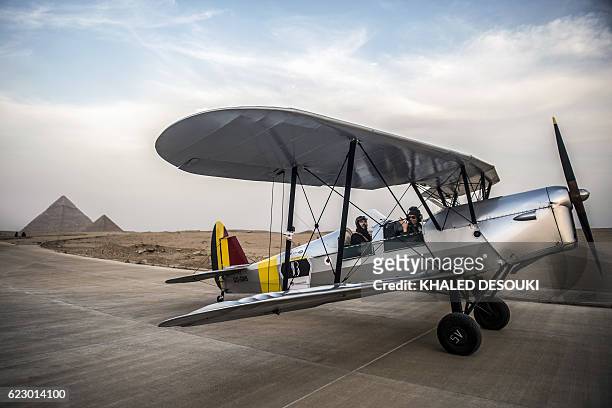 Belgian pilot Alexandra Maingard waves from the cockpit of a Stampe OO-GWB biplane with her husband Cedric Collette behind her at an airfield near...