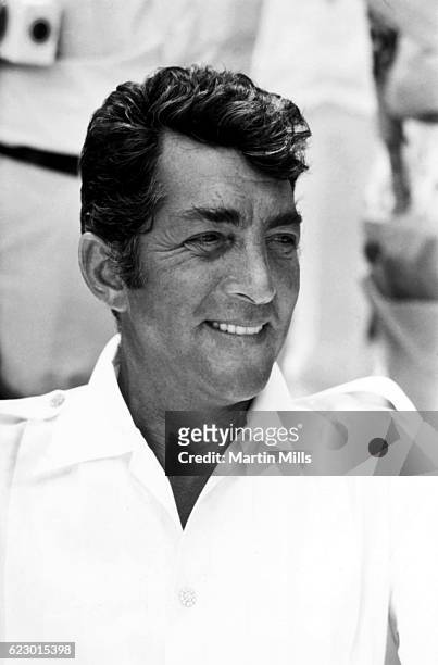 American singer, actor, comedian Dean Martin sits in a chair while on location for "The Ambushers" circa 1967 in Acapulco, Mexico.