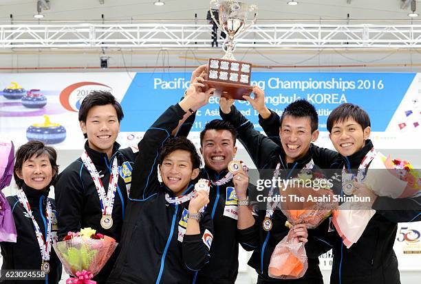 Coach Hatomi Nagaoka, Kosuke Hirata, Kosuke Morozumi, Tsuyoshi Yamaguchi, Tetsuro Shimizu and Yusuke Morozumi of Japan celebrate winning the gold...