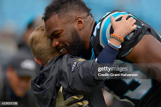 Fozzy Whittaker of the Carolina Panthers hugs a fan before their game against the Kansas City Chiefs at Bank of America Stadium on November 13, 2016...