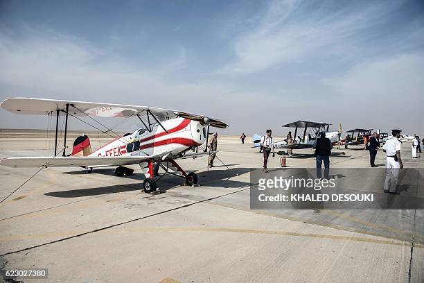 Picture taken on November 13, 2016 shows biplanes on the tarmac of teams participating in the Vintage Air Rally including the German team's Bü 131...