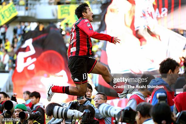 Yoshihiro Uchimura of Consadole Sapporo jumps over photographers to celebrate scoring his team's second goal at the injury time during the J.League...