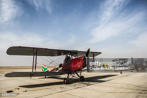 Picture taken on November 13, 2016 shows the DH82A Tiger Moth biplane of the South African team and the Stampe OO-GWB of the Belgium team that are...