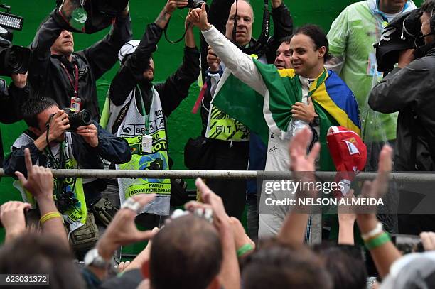 Williams Martini Racing's Brazilian driver Felipe Massa greets fans after his final appearance at Interlagos circuit before retirement, at the end of...