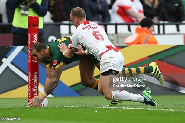 Blake Ferguson of Australia scores a try despite Kevin Brown of England best effort to stop him during the Four Nations between England against...