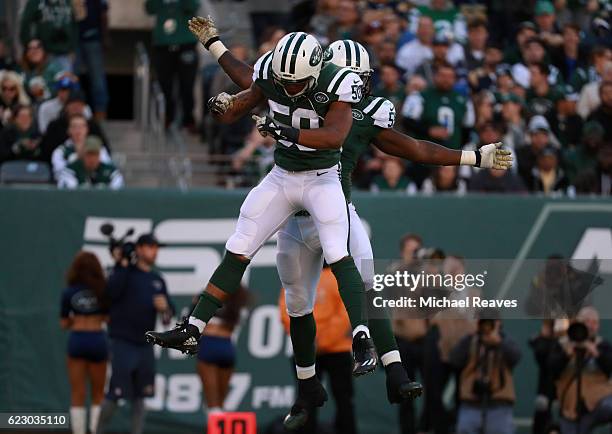 Lorenzo Mauldin of the New York Jets celebrates sacking quarterback Case Keenum of the Los Angeles Rams with teammate Darron Lee in the second...