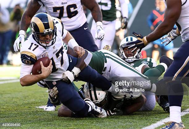 Quarterback Case Keenum of the Los Angeles Rams is sacked by Lorenzo Mauldin of the New York Jets in the second quarter at MetLife Stadium on...