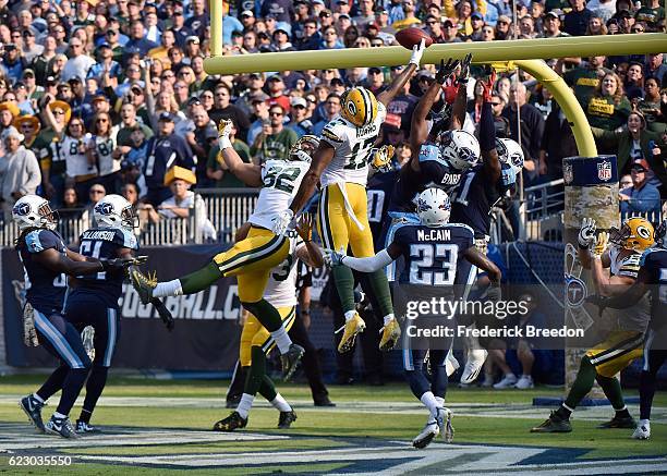 Brice McCain of the Tennessee Titans watches Davante Adams of the Green Bay Packers jump up to try to catch a hail mary pass at the end of the half...